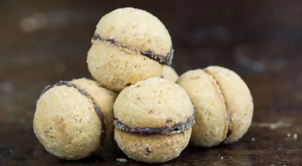 Baci di dama, deliziosi biscotti alle nocciole con un cuore di cioccolato, pronti per essere gustati.