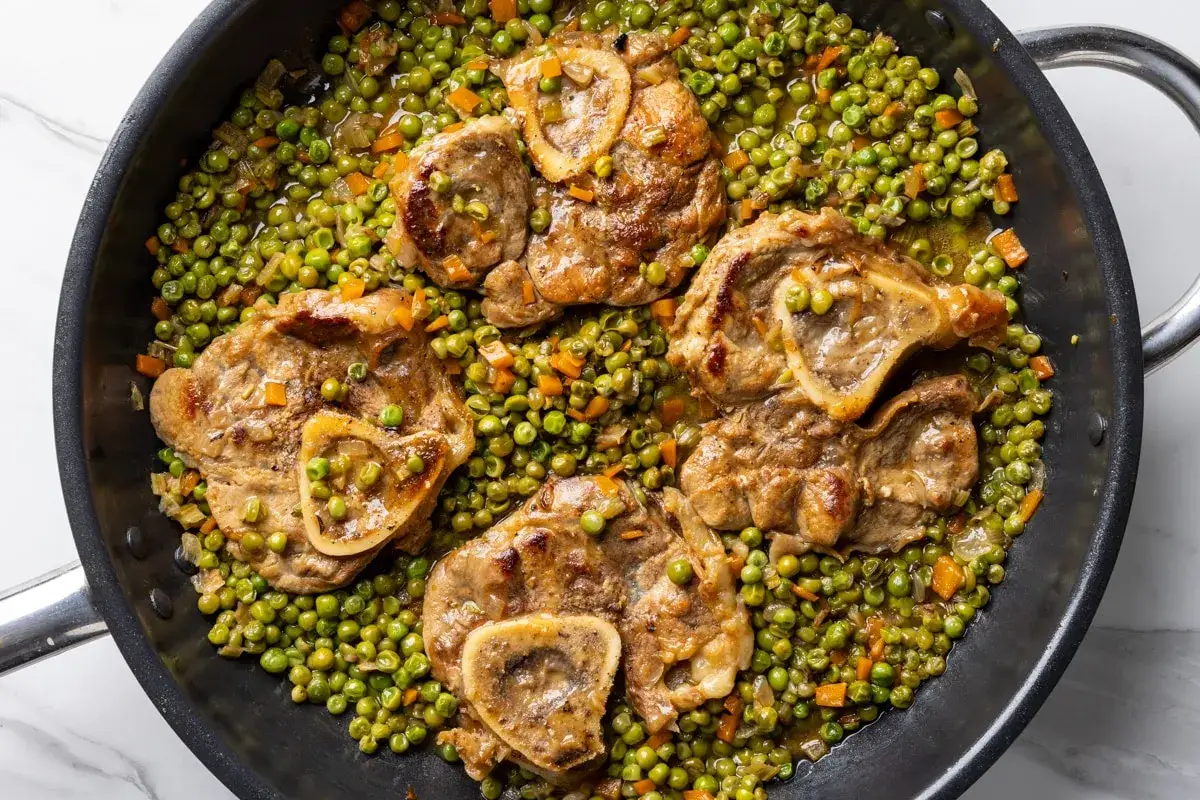 Ossobuco in padella con piselli e carote, una gustosa ossobuco ricetta veloce pronta in poco tempo.